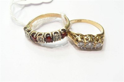 Lot 177 - A diamond three stone ring and a diamond and garnet half hoop ring