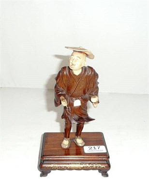 Lot 217 - Carved wood and ivory figure on lacquered base