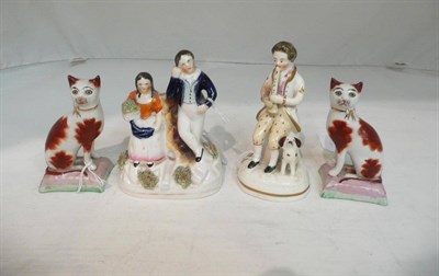 Lot 224 - A pair of Staffordshire cats, a Staffordshire model of a musician and another of a couple