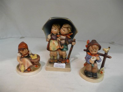 Lot 234 - A large Hummel figure - Children with umbrella and two smaller Hummel figures (3)