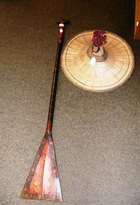 Lot 258 - A red paddle and a hat