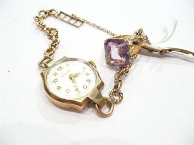 Lot 334 - A 9 carat gold lady's wristwatch by Garrard and an amethyst ring