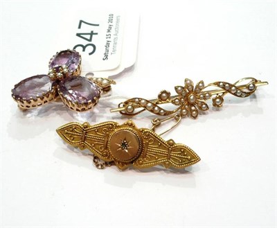 Lot 347 - An amethyst leaf brooch, a seed pearl bar brooch and a diamond set brooch (3)