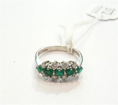 Lot 372 - An 18ct gold emerald and diamond ring