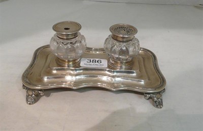 Lot 386 - A William IV inkstand, Joseph & John Angell, London 1832, shaped rectangular on four cast anthemion