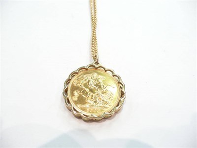 Lot 413 - A year 2000 sovereign coin loose mounted in a 9ct gold pendant frame on a 9ct gold chain