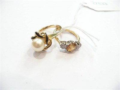 Lot 417 - An 18ct gold cultured pearl and enamel ring and a three stone ring (2)