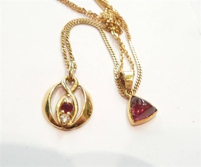 Lot 428 - An 18ct gold ruby and diamond three stone pendant on chain and an earring and pendant set