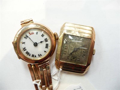 Lot 451 - A 9ct gold wristwatch with a stepped bezel, and a lady's 9ct gold wristwatch