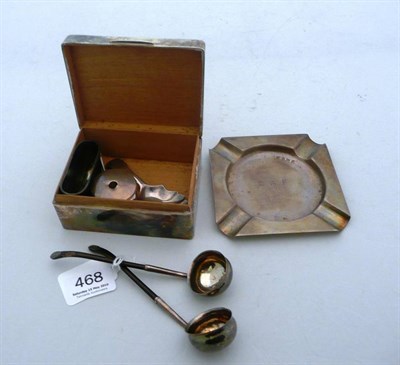 Lot 468 - A silver engine turned cigarette box, an ash tray, an ink well and silver hip flask mount, two...