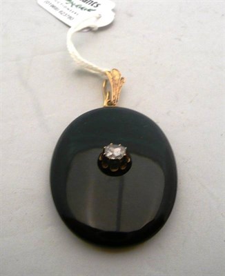 Lot 469 - A Victorian onyx and diamond locket pendant, the large oval onyx suspended from a textured...