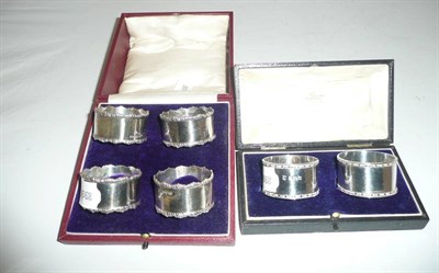 Lot 500 - A cased set of four silver napkin rings and a pair of cased silver napkin rings