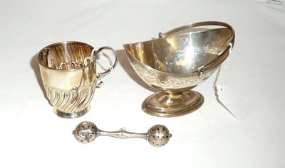 Lot 542 - An oval silver sugar basket, a small silver mug, a baby's rattle a/f