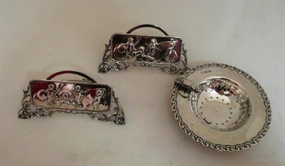 Lot 545 - Pair of silver menu holders and silver strainer