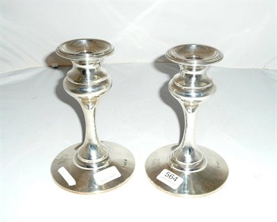 Lot 564 - Pair of loaded silver candlesticks, Birmingham assay 1907