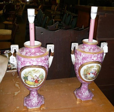 Lot 579 - Pair of pink ground Continental two-handled table lamps