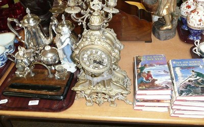 Lot 605 - Brass clock garniture, plated teaset, inkstand and figure and Enid Blyton books, 10 volumes