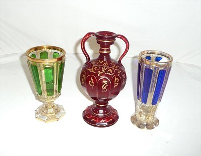 Lot 614 - German ruby glass water ewer and two overlay glass goblets