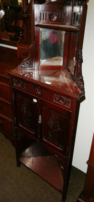 Lot 705 - A late Victorian carved walnut corner cupboard with mirrored back