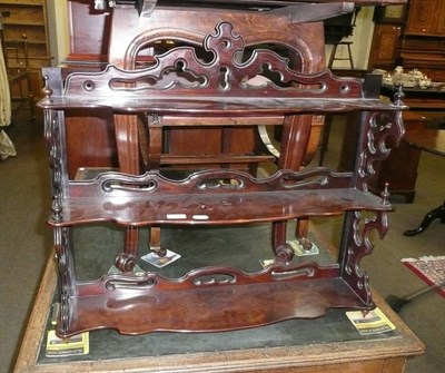 Lot 734 - A rosewood three tier wall mounted shelf