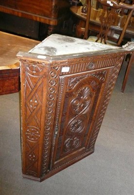 Lot 754 - Carved oak corner cabinet