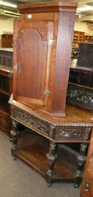 Lot 794 - An oak corner cabinet and a carved oak side table