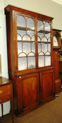 Lot 827 - 19th century mahogany glazed bookcase on cabinet