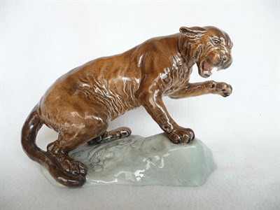 Lot 1112 - Beswick Puma on Rock style two, model No. 1823, tawny cat on grey ceramic rock base, gloss,...