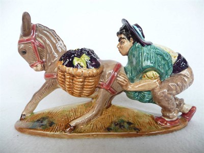 Lot 1145 - Beswick Spaniard Pushing Donkey, model No. 1224, he wears yellow spotted shirt and pale brown...