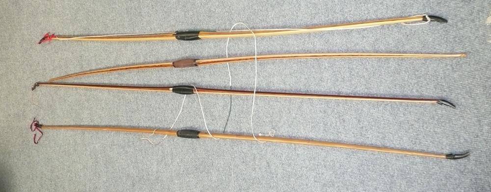 Lot 58 - Four Laminated Wood Longbows, varying sizes