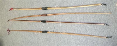 Lot 58 - Four Laminated Wood Longbows, varying sizes and strengths, mixed woods, each with leather hand...