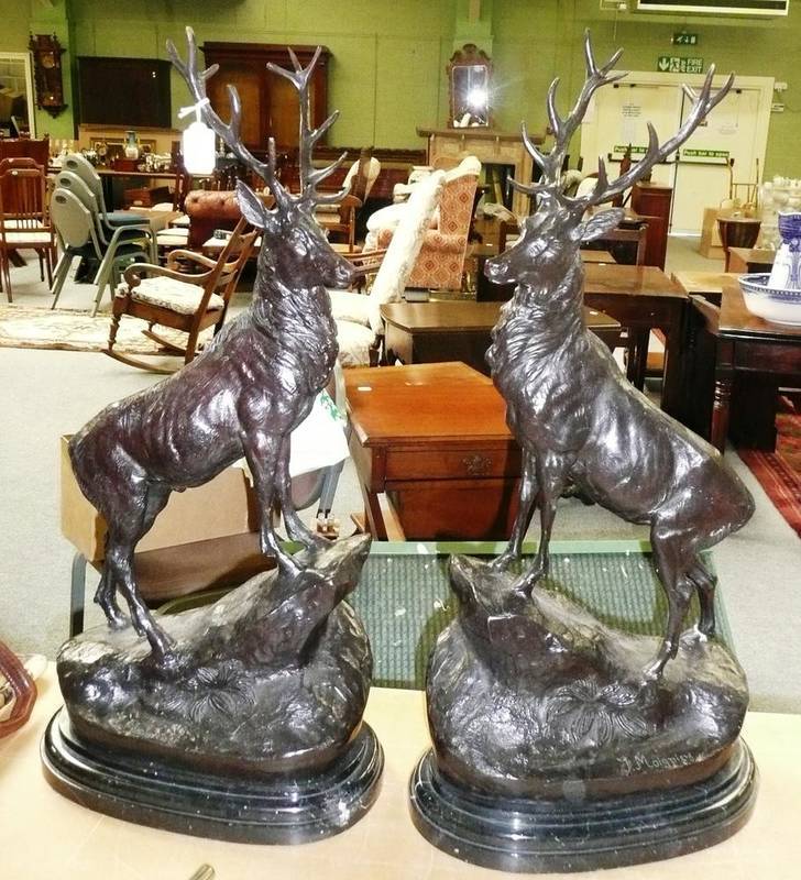 Lot 110 - After Moigniez - A Pair of Modern Bronzed Metal Figures of Stags, each standing on an upswept rocky