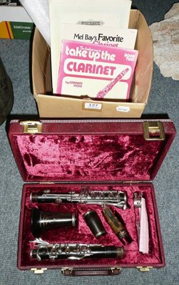 Lot 127 - A cased clarinet by Rudall Carte together with stand and sheet music