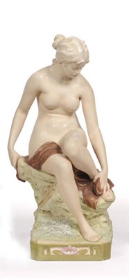 Lot 68 - A Royal Dux Bohemia Figure of a Nude Young Woman, early 20th century, she sits on moss covered...