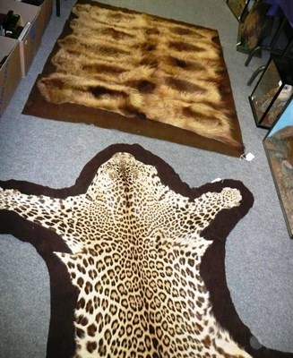 Lot 227 - A Leopard Skin Rug, pre 1947, with brown felt lining, 222cm by 146cm, and another farmed fur...