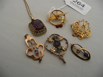 Lot 264 - An Art Nouveau brooch, an enamelled brooch, another brooch and three pendants with a chain