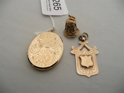 Lot 265 - A 9 carat gold engraved locket, a shield fob and a bell charm