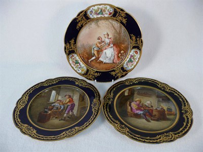 Lot 83 - A Pair of "Sevres" Porcelain Dessert Plates, painted after David Teniers, circa 1880, each of lobed