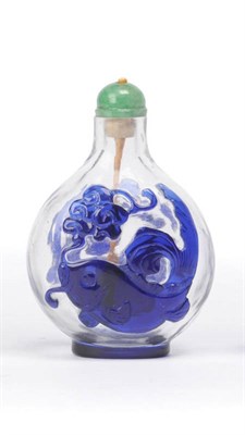 Lot 150 - A Blue Overlay Glass Chinese Snuff Bottle, 18th/19th century, the clear glass body overlaid in blue