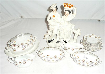 Lot 31 - A child's pottery dinner service and a Staffordshire figural group