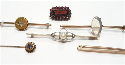 Lot 76 - A diamond set bar brooch, three bar brooches, a stick pin and a garnet brooch (6)