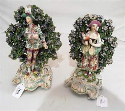 Lot 168 - Pair of 18th century English porcelain figural groups of a lady and gent holding a bird (a.f.)