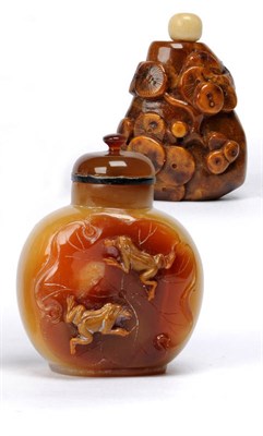 Lot 170 - An Agate Snuff Bottle, with deep rust inclusion carved with frogs and lotus leaf, 7cm; and An Amber