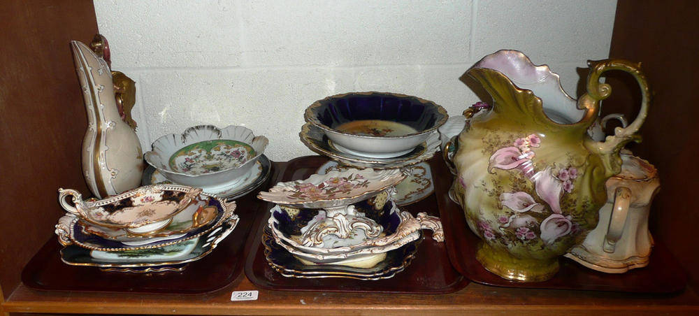 Lot 224 - Tea wares, 19th century clock, cabinet plates, teapots, pottery jugs etc on two shelves