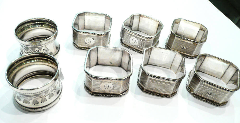 Lot 261 - A set of six silver napkin rings and a pair of silver napkin rings