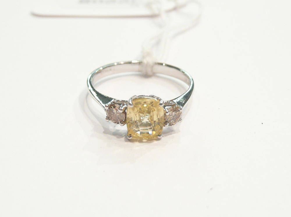 Lot 275 - A 14ct white gold yellow sapphire and diamond ring