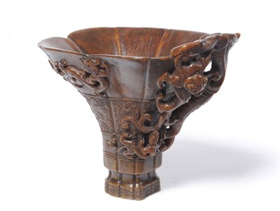 Lot 183 - A Rhinoceros Horn Libation Cup, circa 1650-1700, finely carved with archaistic taotie masks to...