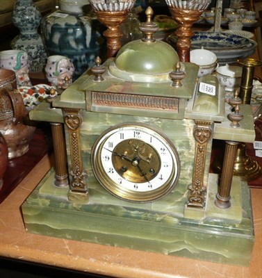 Lot 359 - An onyx striking mantel clock