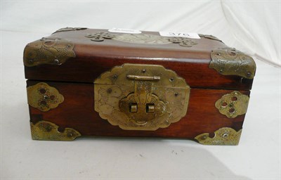 Lot 376 - A Chinese wooden casket with oval jade plaque, brass clasp and corners