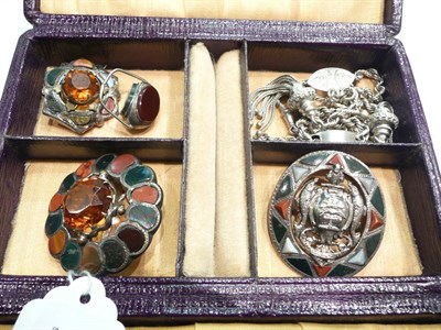 Lot 430 - Three Scottish hard stone brooches, silver Albert and a fob in a purple jewellery box